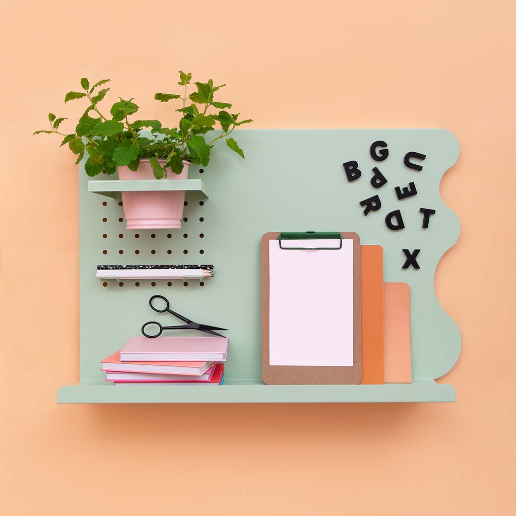 black wordbts letters displayed on a sage green Peg & Board magnetic memo board