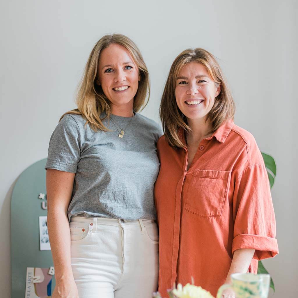 Photo of Wordbits founders Shanna hermansen and Annabel Weber (Annabel Jenkins) standing together two women smiling